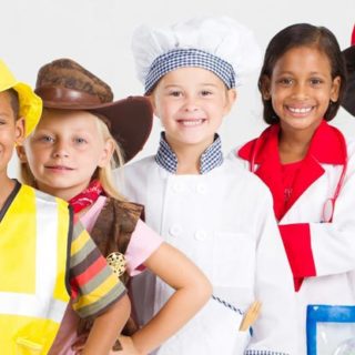 Group of children wearing outfits of common careers.